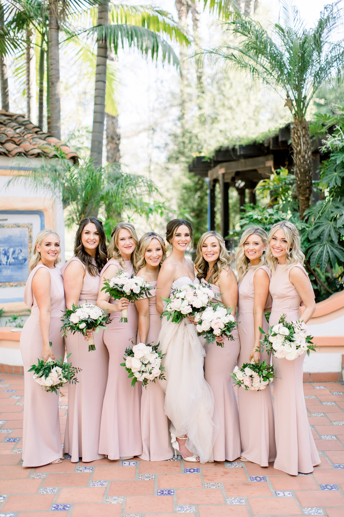 Bridal party in blush gowns in a Spanish courtyard