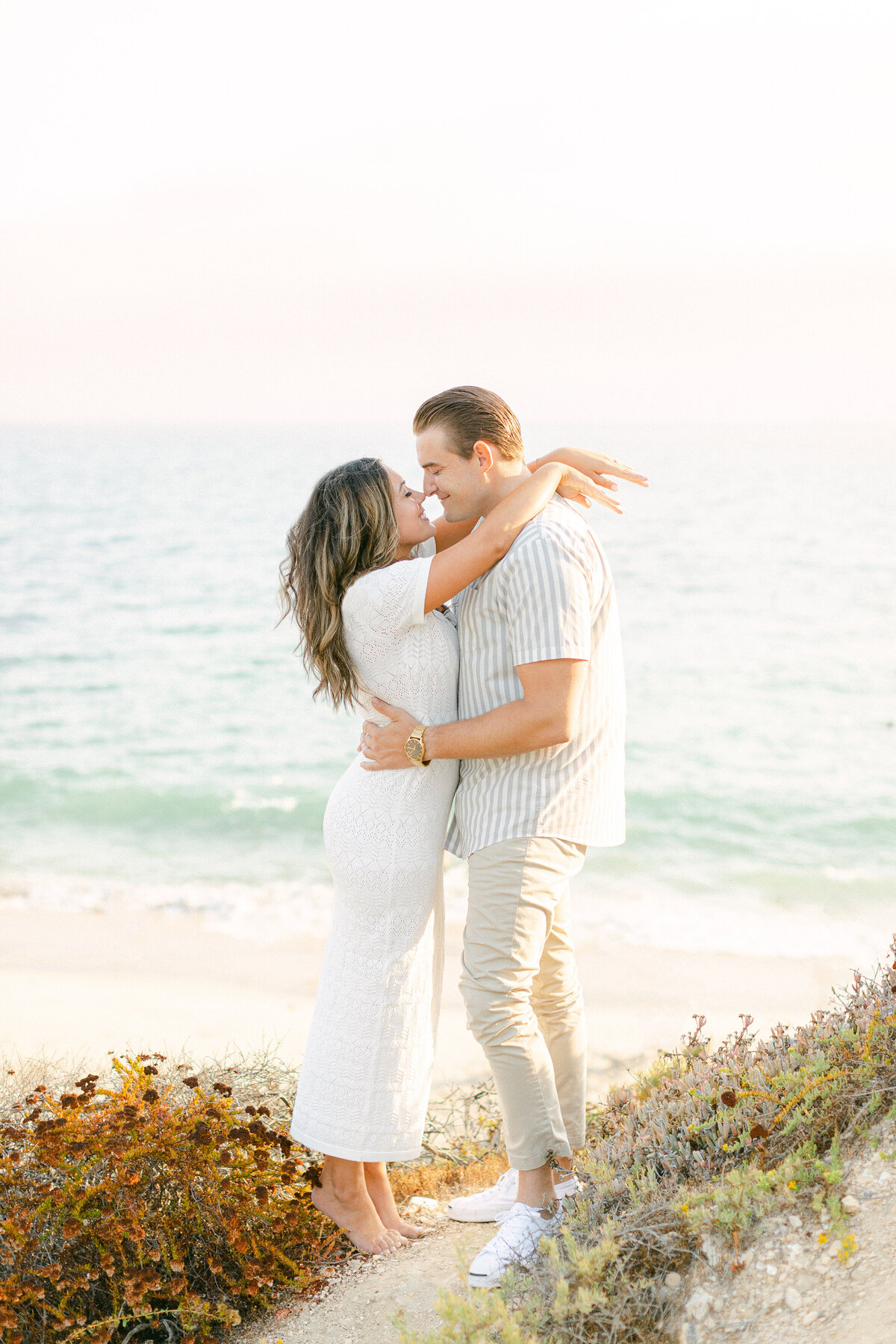 Couple on a coastal bluff at golden hour