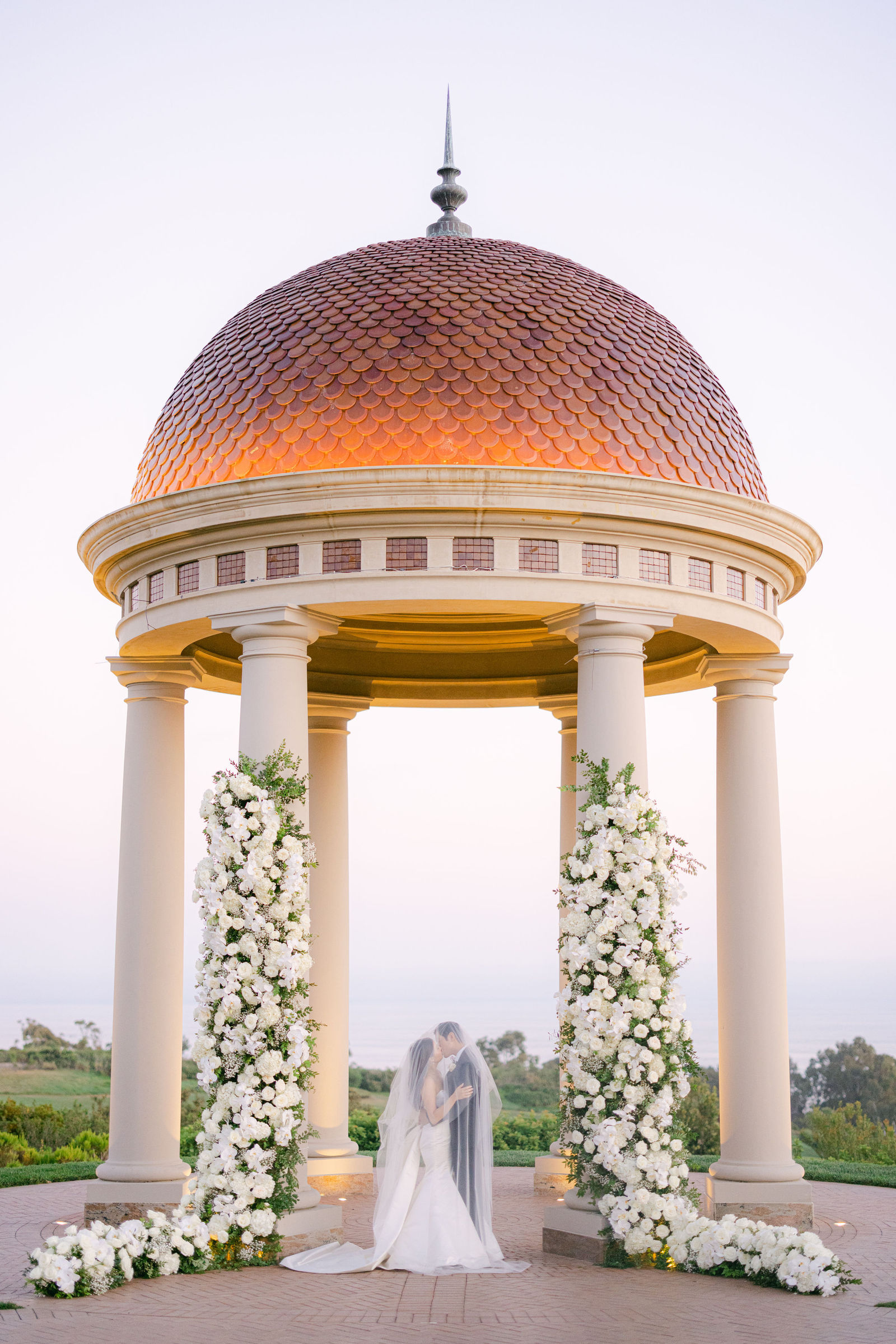 The rotunda glowing at dusk, Erica and Nick beneath it