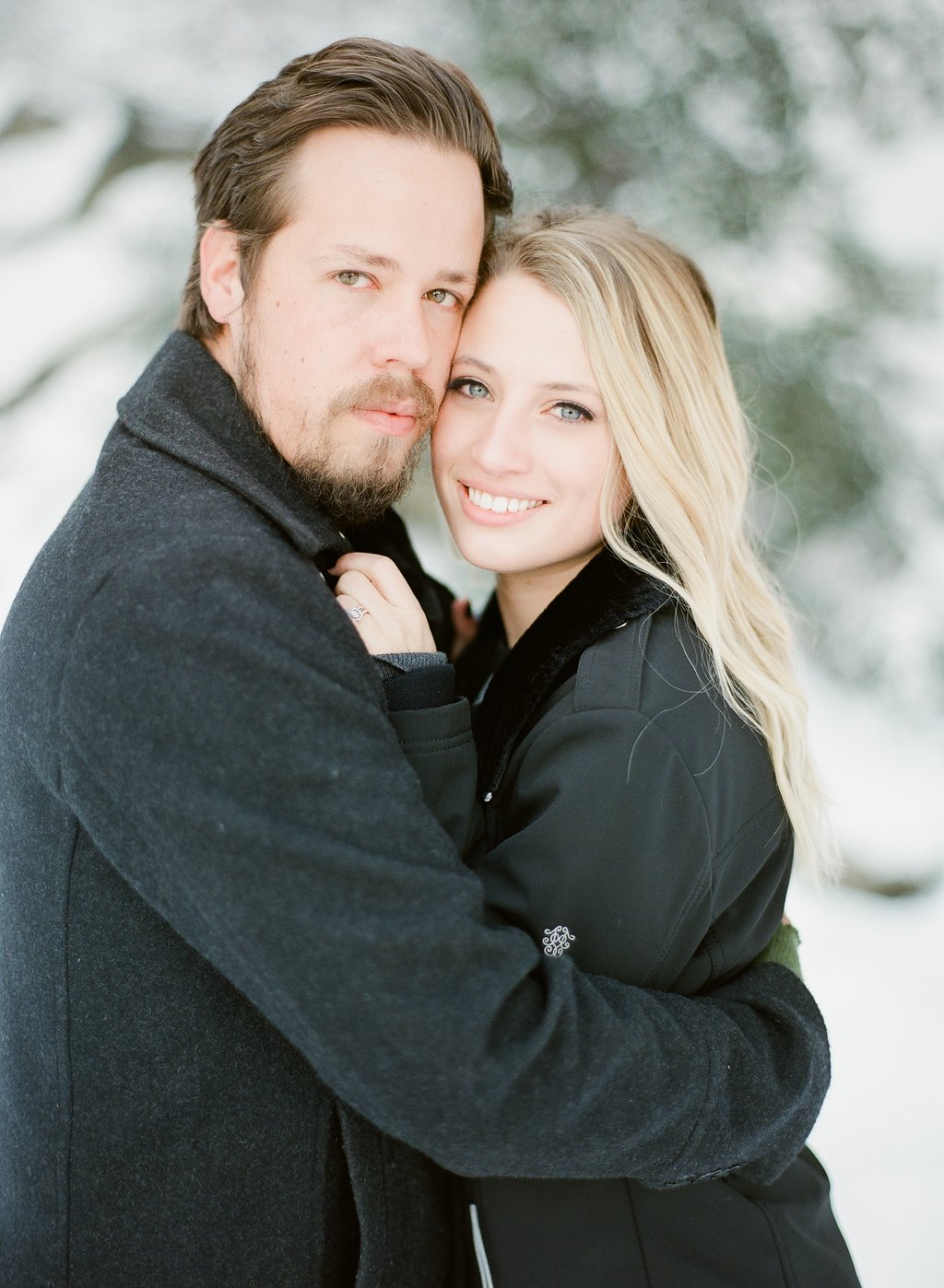 Cynthia resting her head against James, engagement ring catching the light