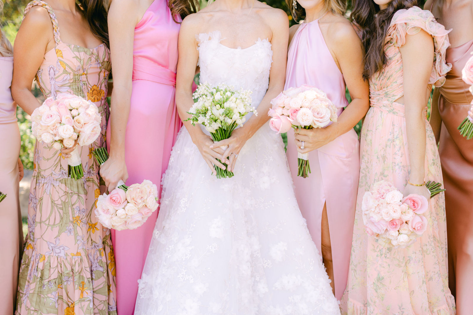 The bridesmaids' bouquets in every shade of pink
